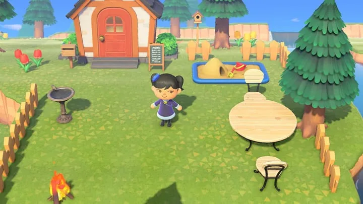 Official ACNH screenshot showing outdoor furniture and fencing around a villager home